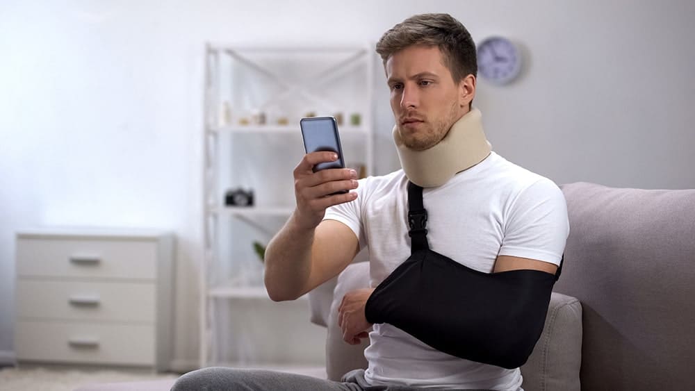 man wearing arm sling after rotator cuff surgery