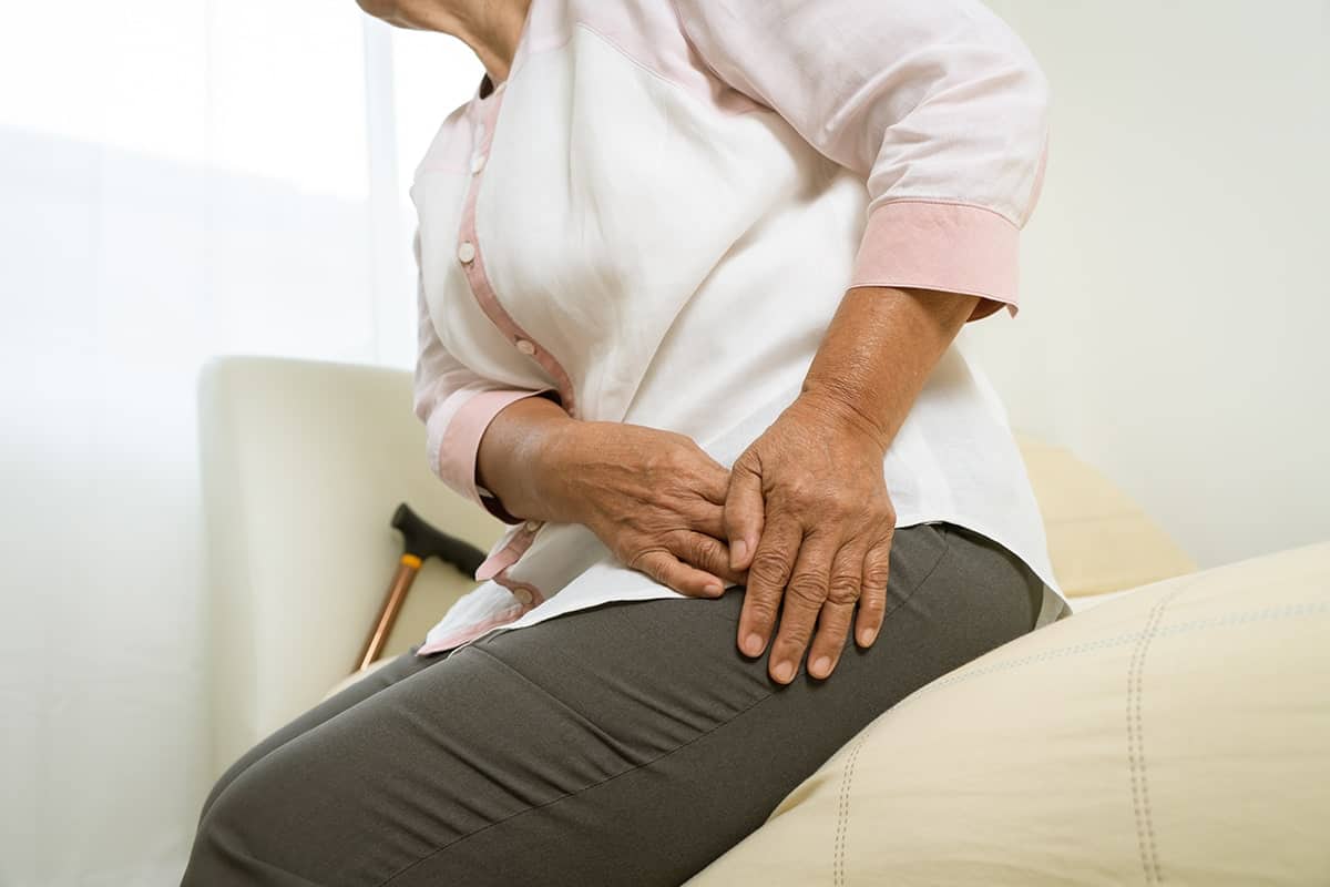 aged woman waking up with hip pain at night