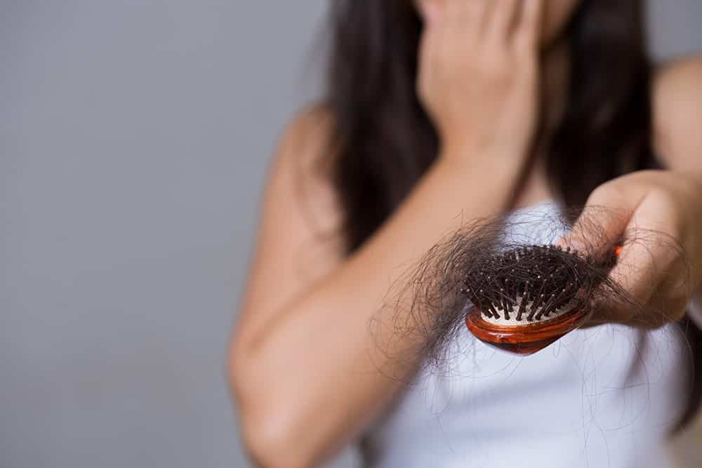 girl worried about hair loss