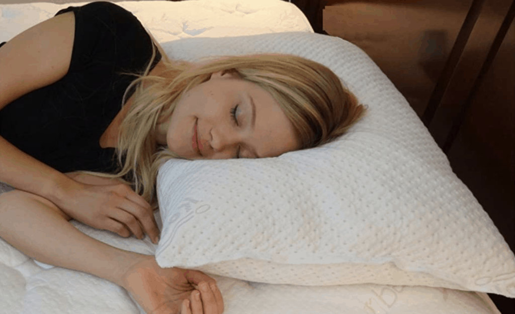 A woman sleeps on a memory foam pillow