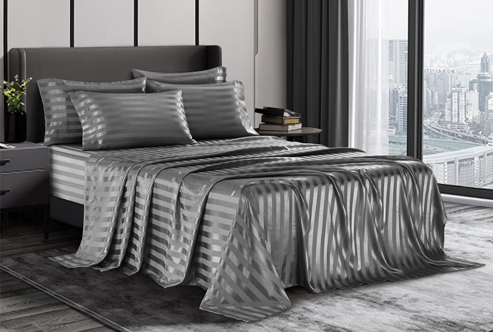 grey striped satin sheets on bed