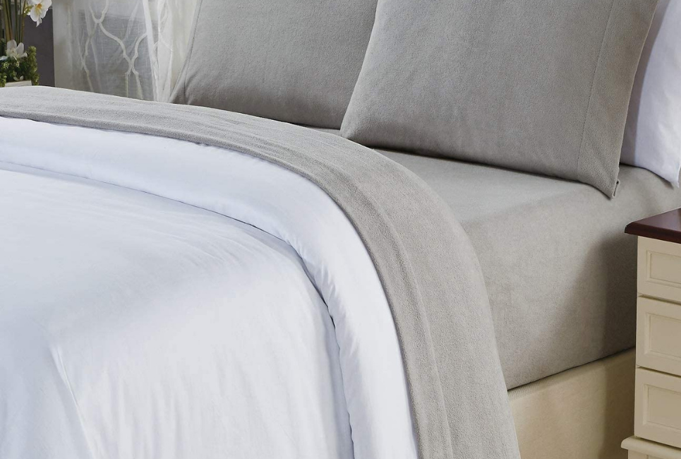 taupe fleece sheets on bed with white blanket