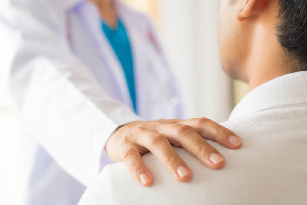 Doctors' Hand on Patient Shoulder