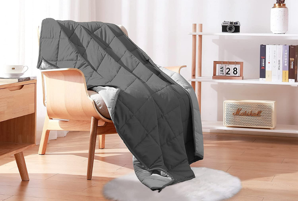 grey cooling weighted blanket draped over chair