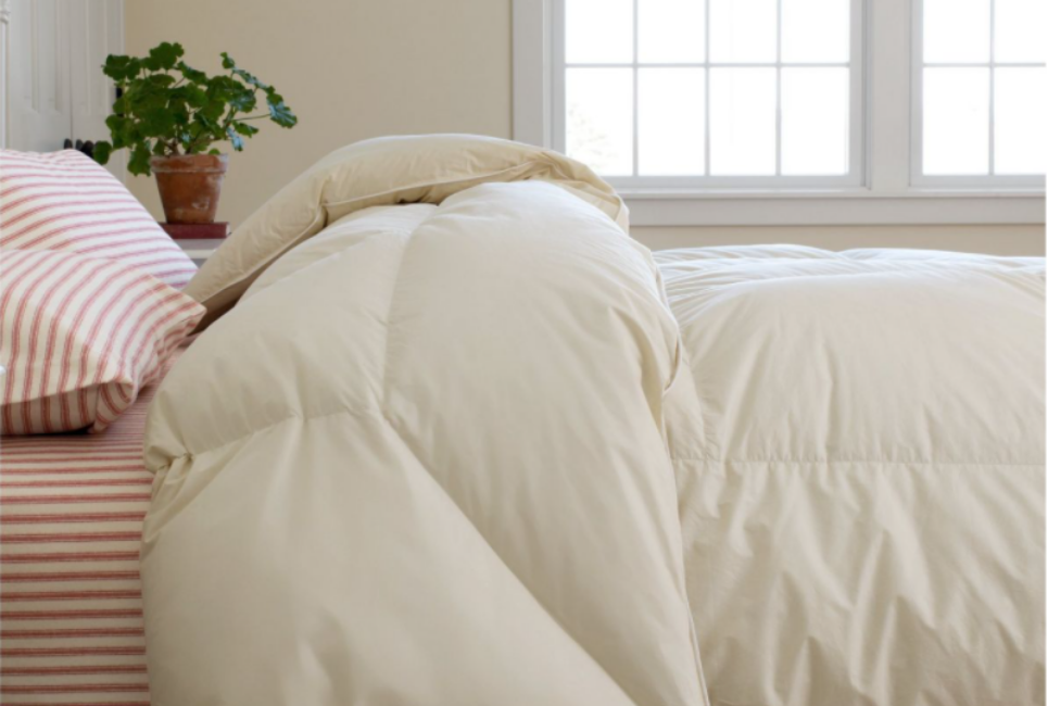 cream comforter on bed shown from side