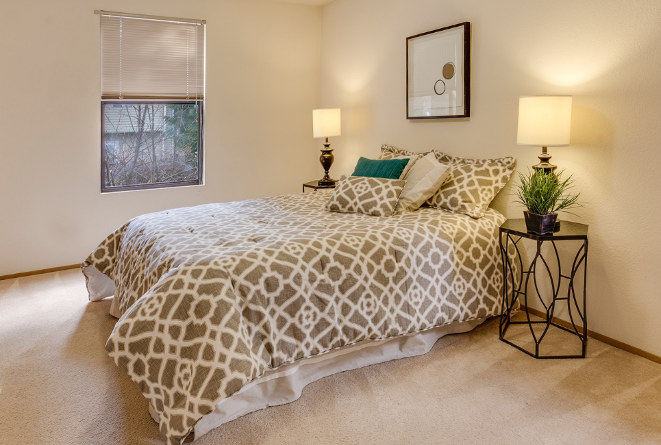 elegant taupe and white patterned comforter on bed