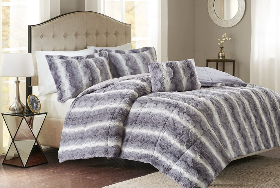 blue and white striped faux fur comforter on bed