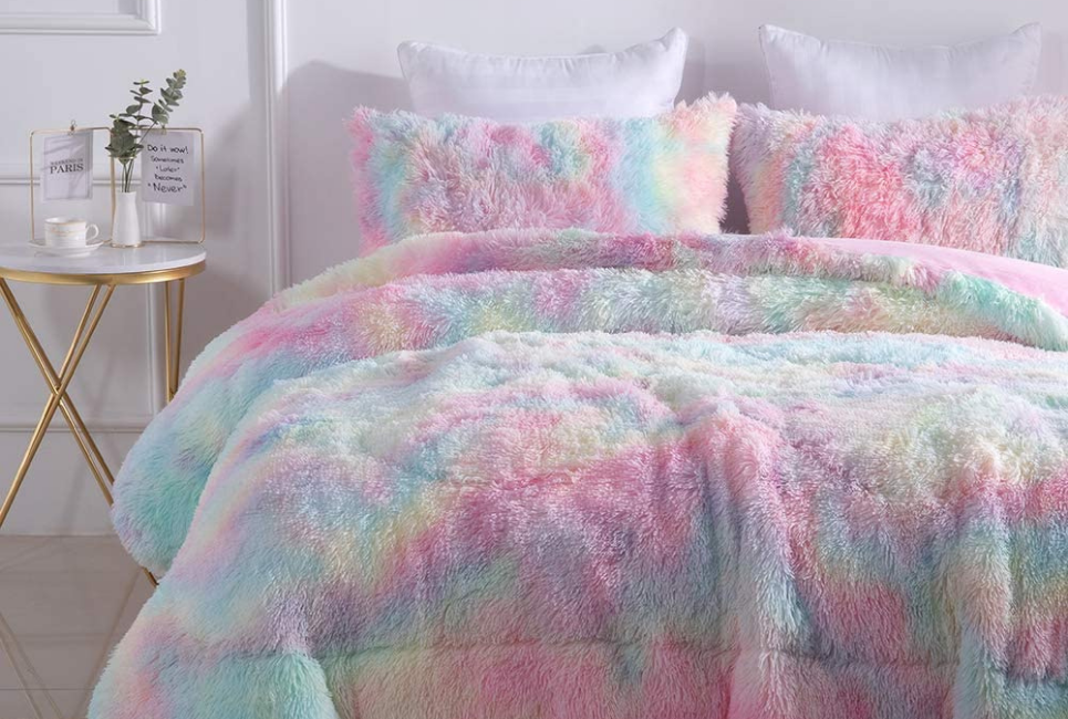 rainbow colored faux fur comforter on bed