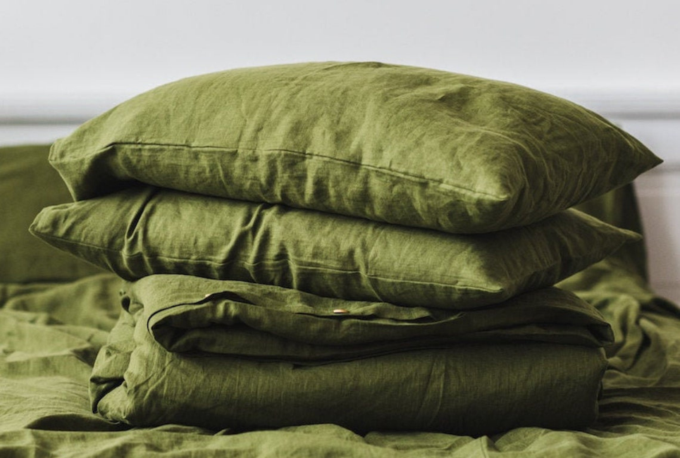 Olive green sheets and pillowcases on bed
