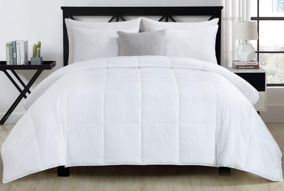 White neatly made bed with plush comforter