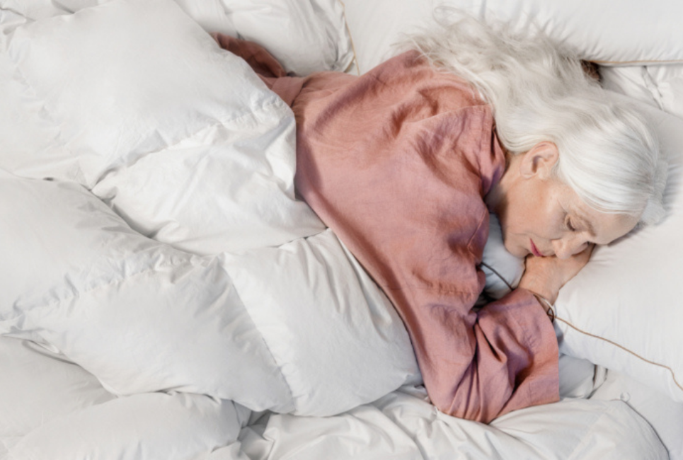 woman sleeping peacefully in white bedding