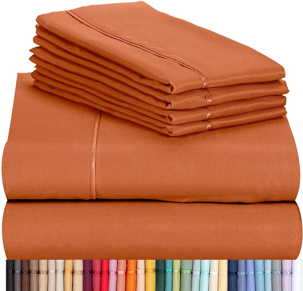 neatly folded orange sheet set featured above mutliple sheet color options