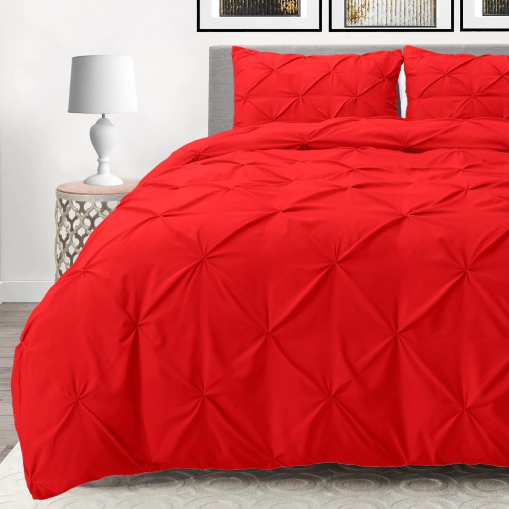 Red Pintuck Comforter on bed