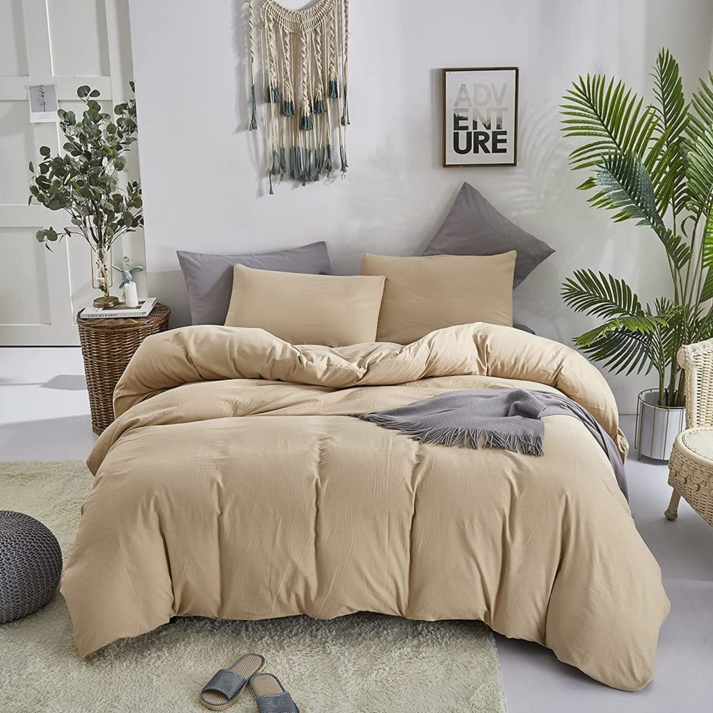 beige comforter set styled in neutral boho room