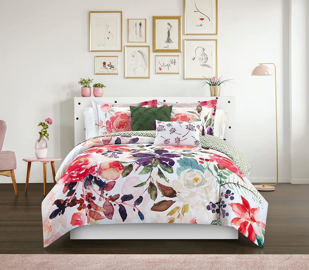 White and floral print bedding in clean modern room with feminine sketches behind bed