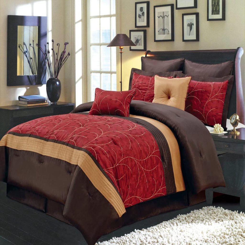 Red, Gold and Brown Comforter on bed