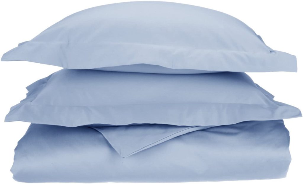 light blue sheets folded neatly and stacked with pillows