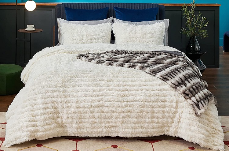 Shaggy ultraplush white comfoter on bed in moody bedroom