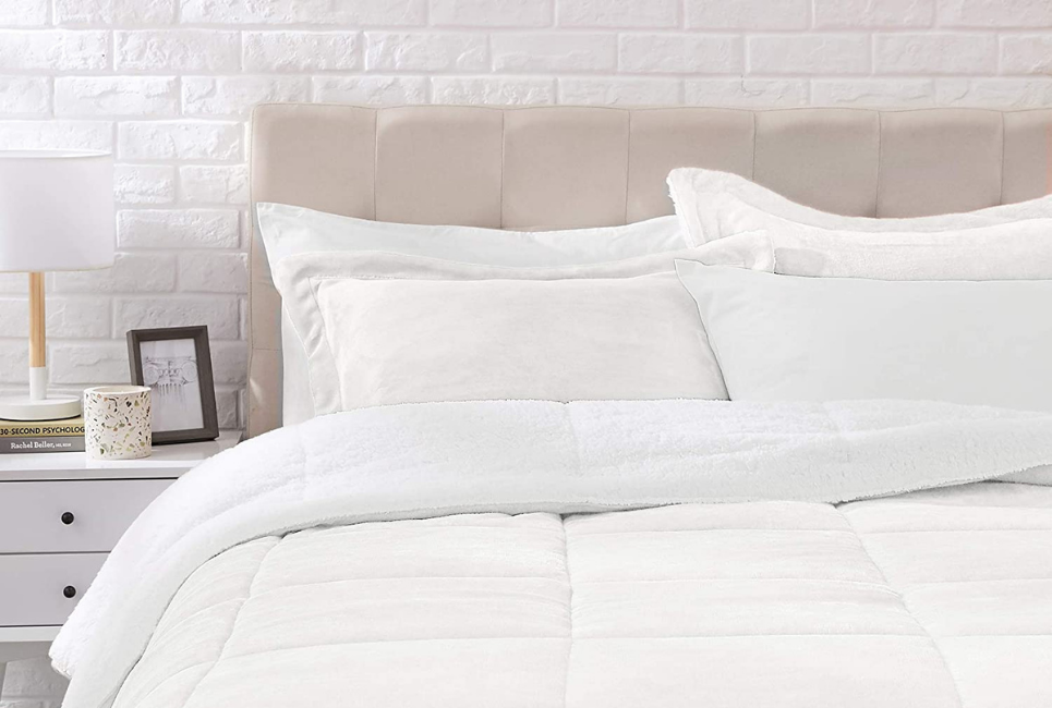 cream comforter on bed in clean room