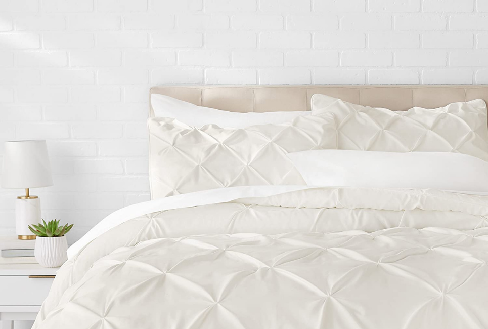 cream pinch pleat comforter on bed