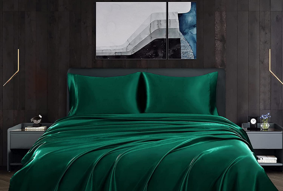 satin dark emerald green sheets in dark luxurious bedroom