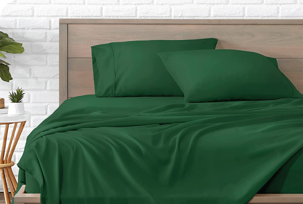 forest green sheet set on bed