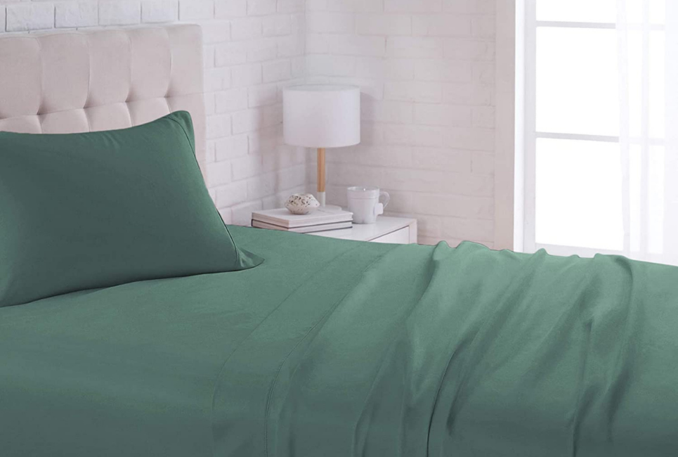 muted teal green sheets on bed