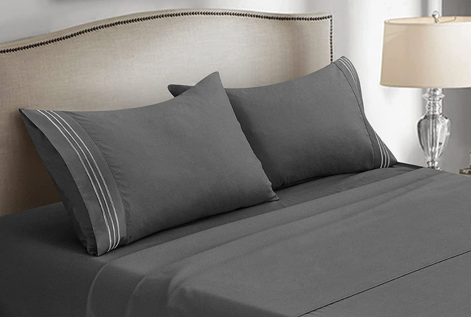 dark grey sheets on elegant bed