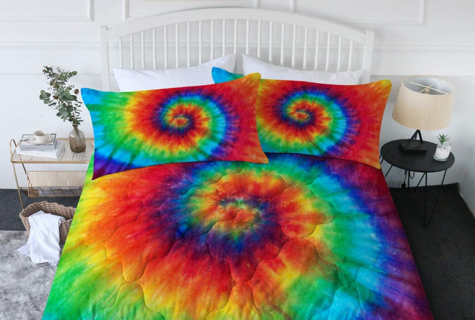 rainbow tie-dyed comfoter and pillows on bed in clean room