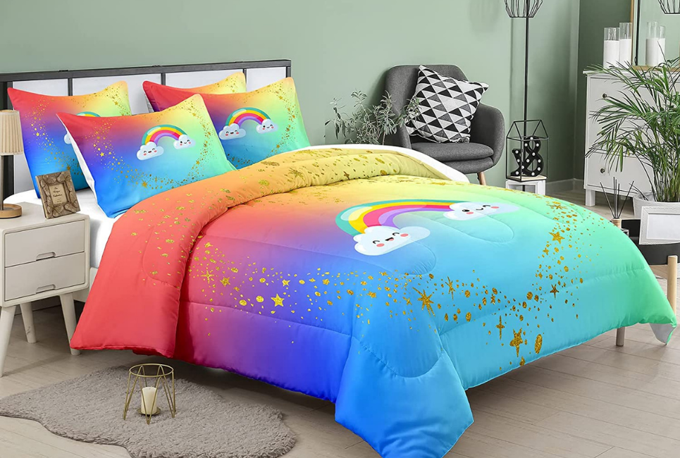 multicolored comforter on bed with glittery stars and cartoon smiling rainbows pattern