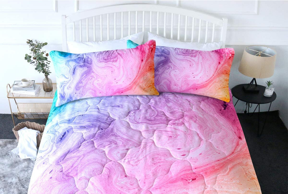 marbled multicolored comforter and pillow shams on bed