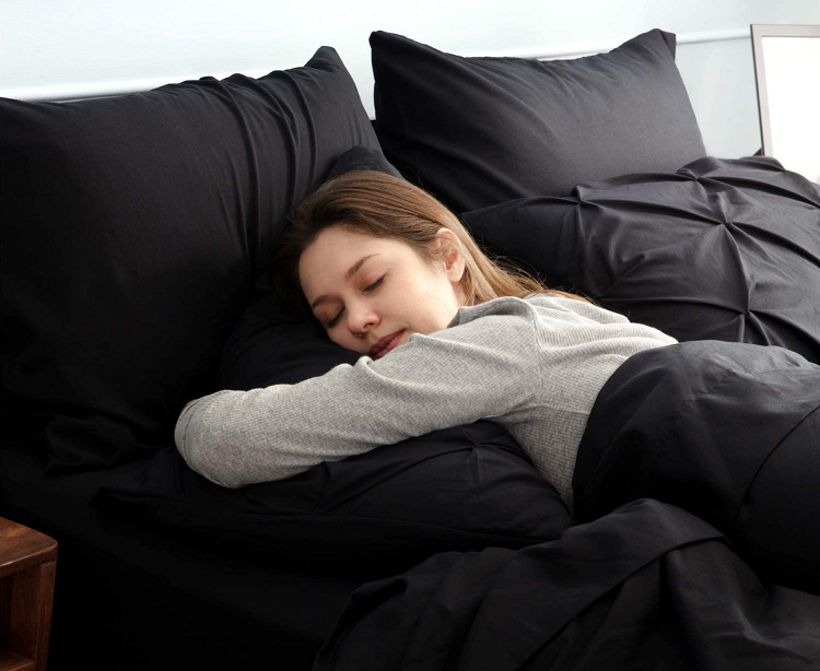 Woman sleeping on black comforter