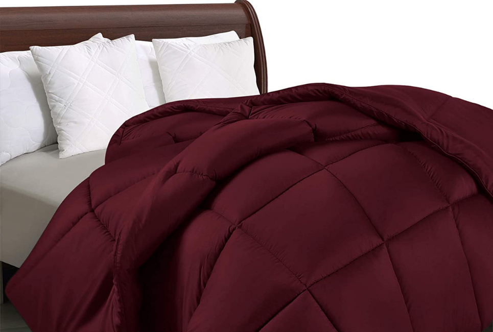 Burgundy Cozy Comfoter on unmade bed