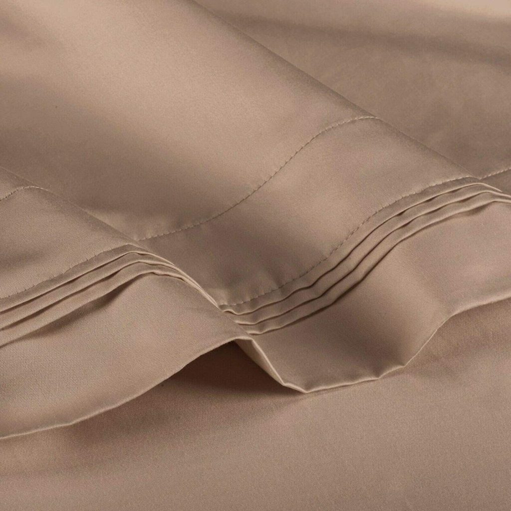 close up of stitching on taupe brown sheets