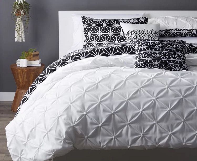 Drennan Microfiber Reversible Comforter Set in black and white geometic pattern on bed with pillows