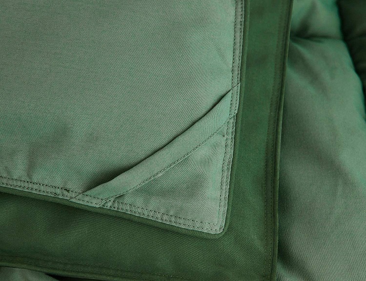 Folded Corner of Green Comforter