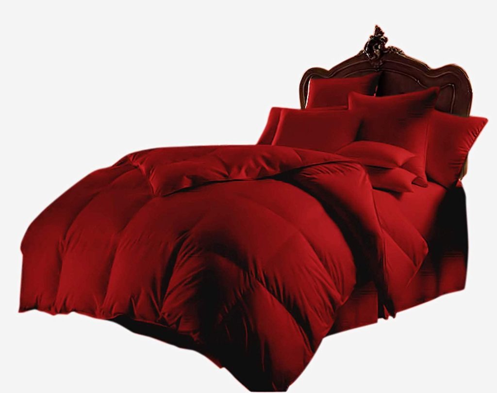 plush, cozy bed with red bedding and pillows