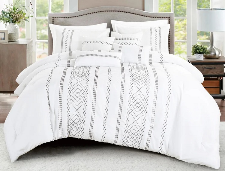 white geometric lines design on comfoter on bed