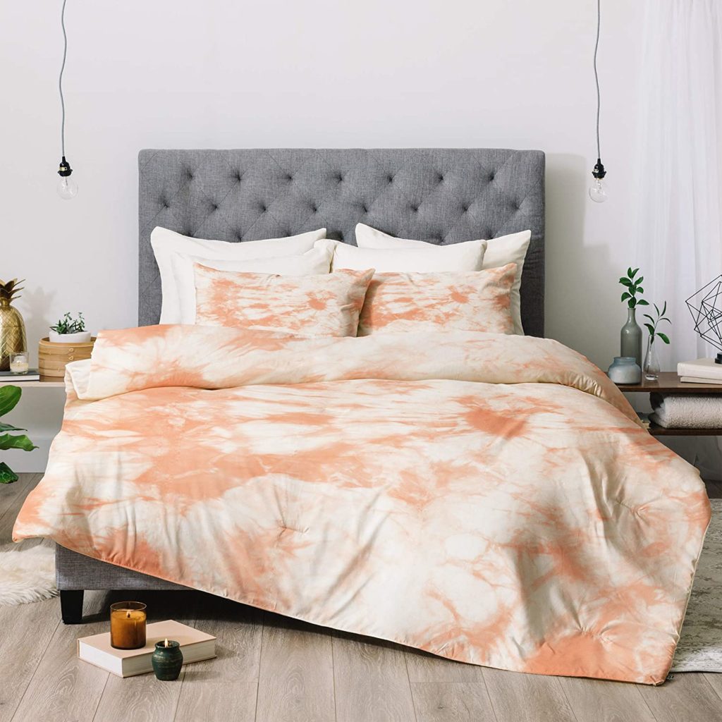 Orange and White tie dyed bedding set in cozy bedroom