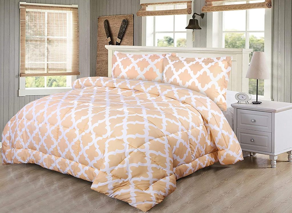 white and beige patterned bedding set in clean bedroom