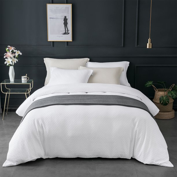 Black and white moodern bedroom vignette with clean white bedding