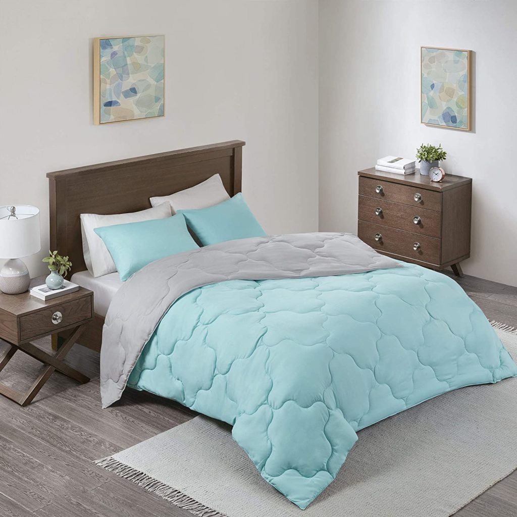 aqua and grey reversible comforter on bed