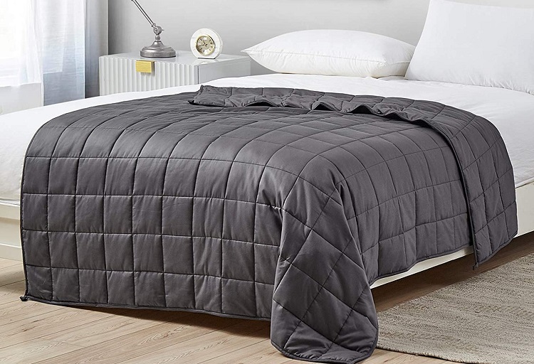 bed made with grey weighted blanket