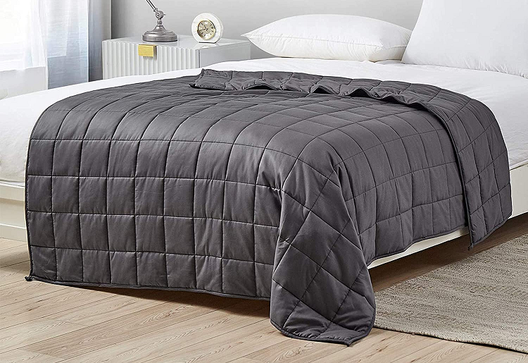bed made with grey weighted blanket