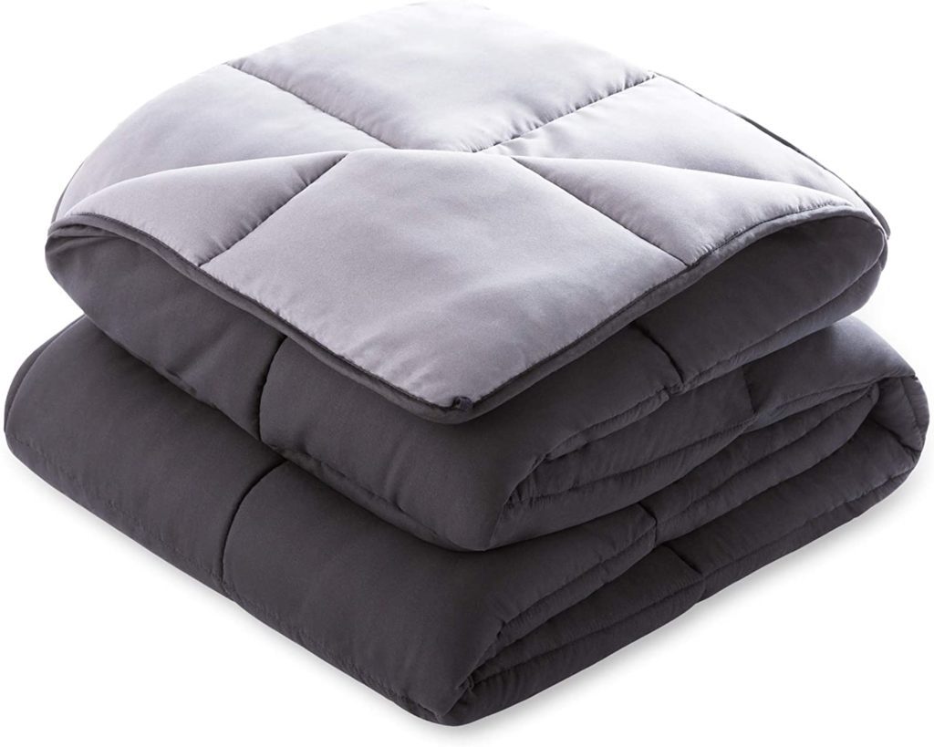 black and grey reversible comforter folded neatly