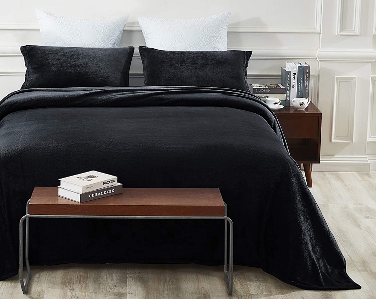 black fleece sheets on bed in trendy room