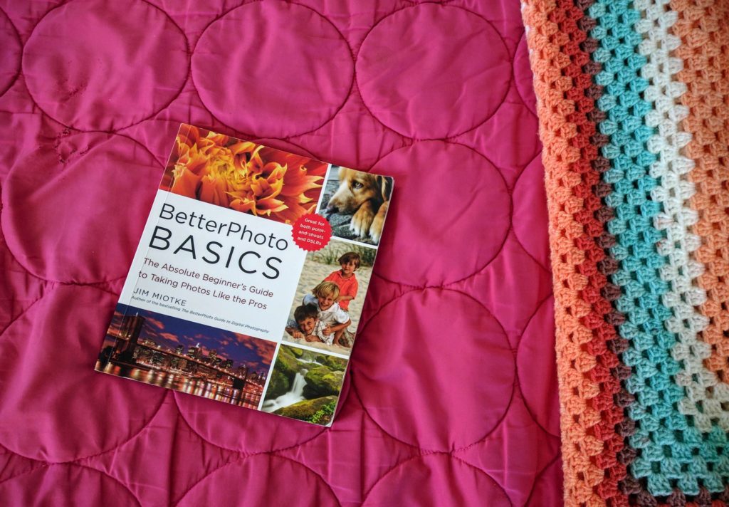 book about photography on a pink bed