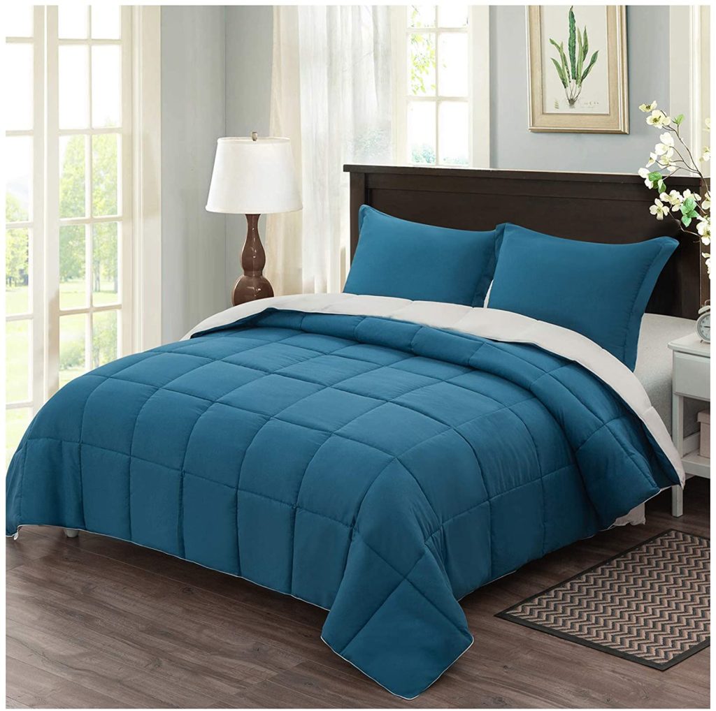 box stitch teal comforter on bed in clean room