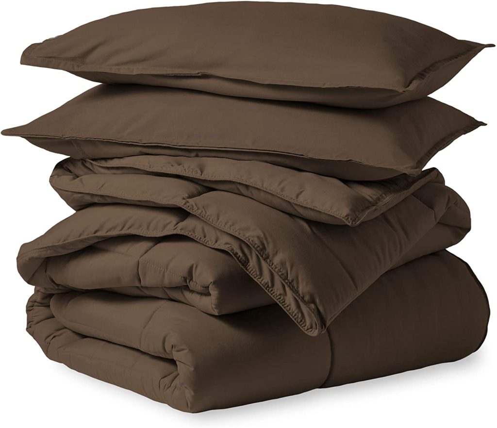 brown comforter and bedding set stacked neatly