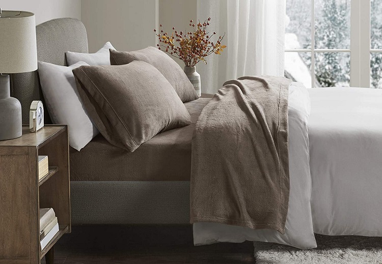 brown fleece sheets on bed in cozy room